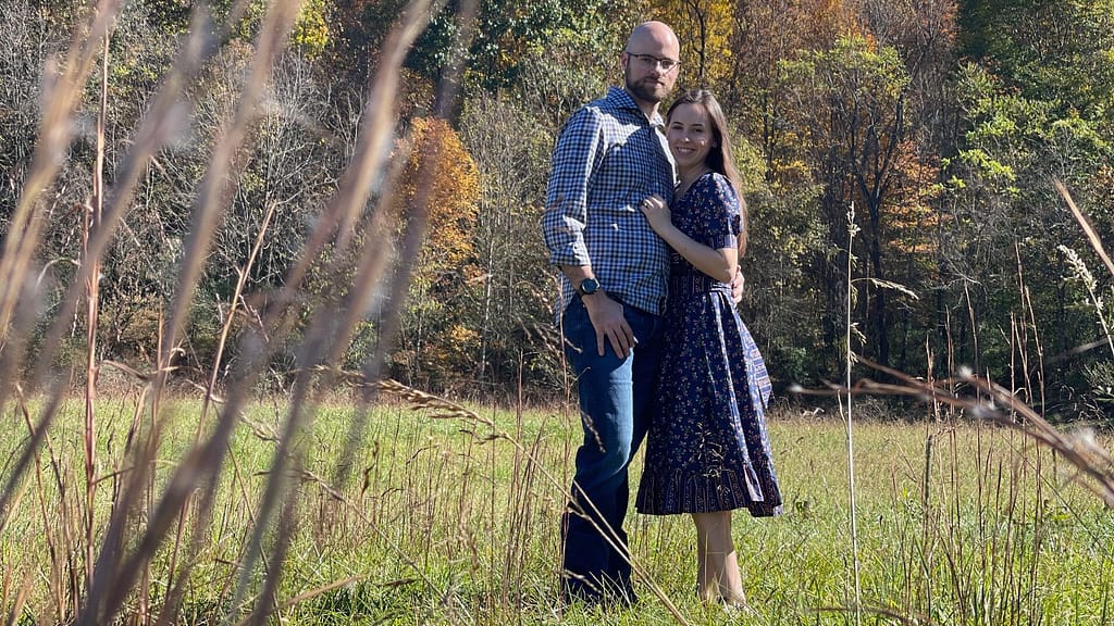 man and woman standing in a field