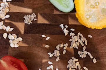 vegetables and seeds on a cutting board