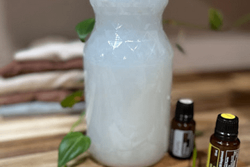 white soap in a bottle on a wooden counter
