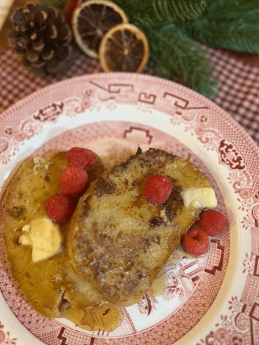 French Toast on a plate with pine cone and dried oranges in the background