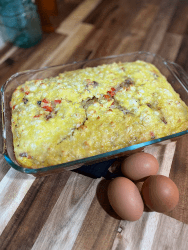 quiche in a baking dish with three eggs in front